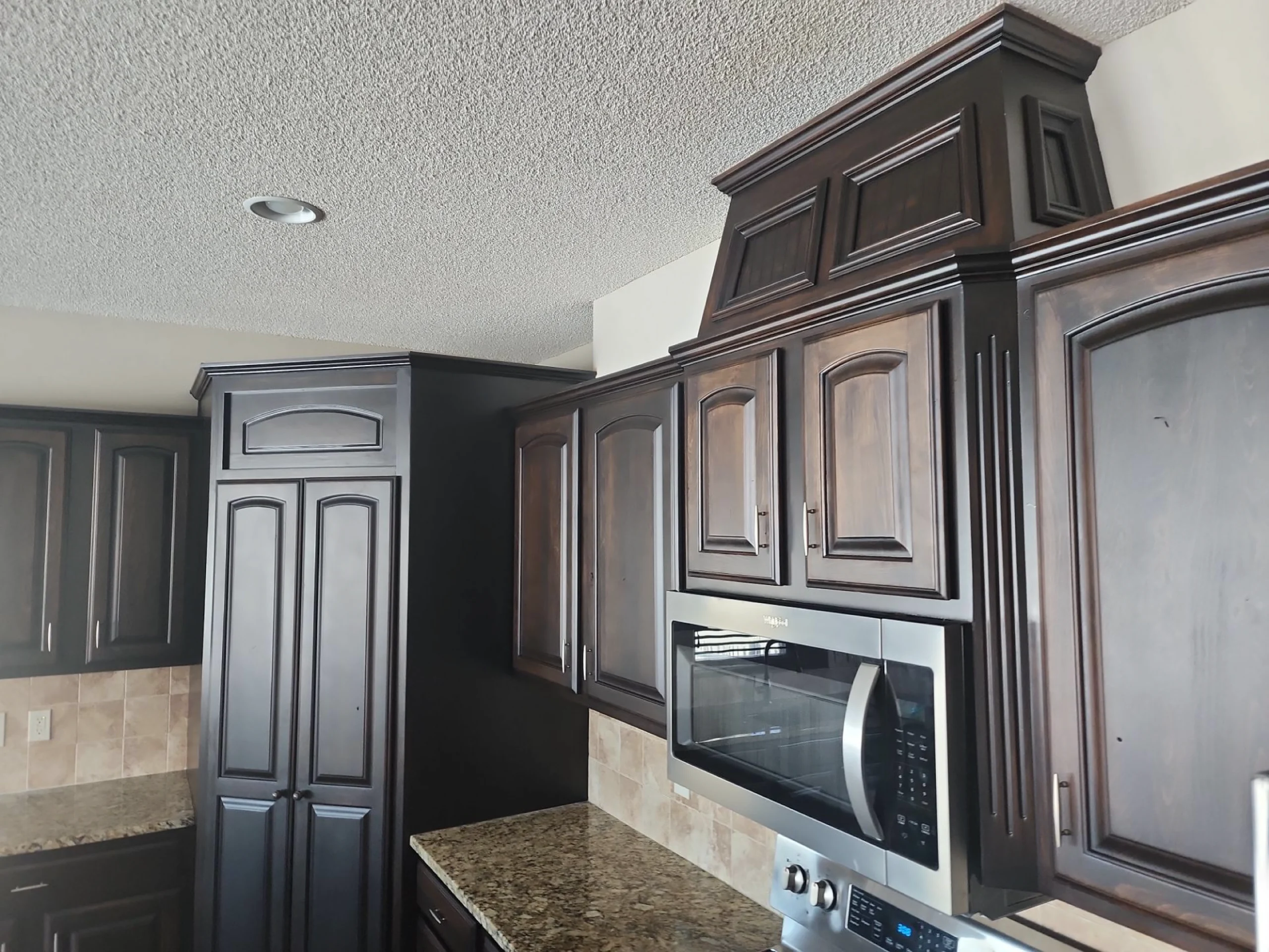 dark espresso wood kitchen cabinets updated with professional refinishing from River City Painting