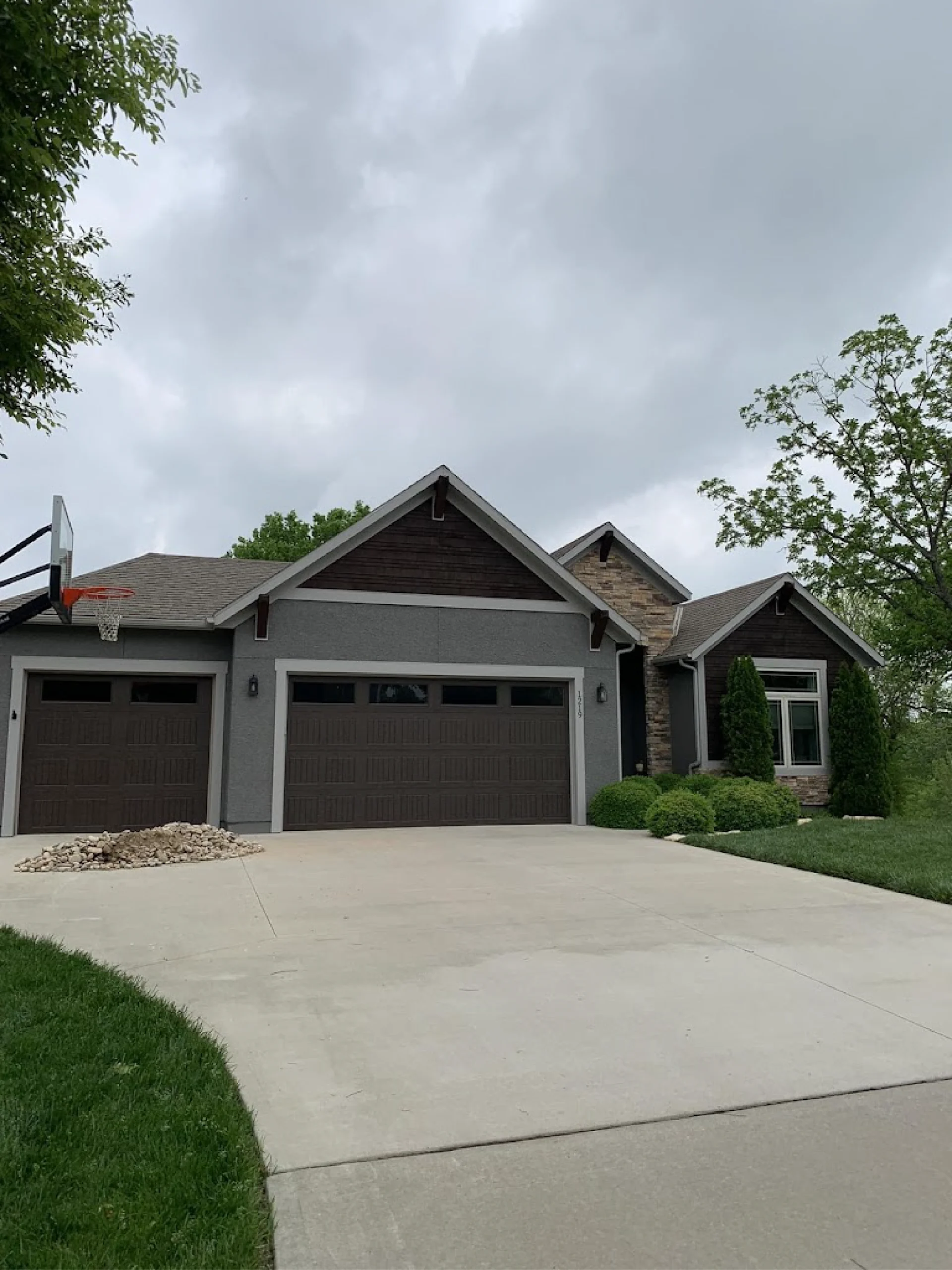 house painting near me featuring a neutral color palette that pairs great with the home's natural stone accents